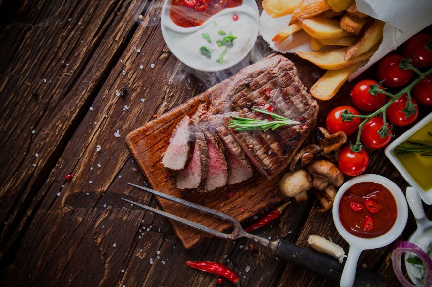 Delicious beef steak on wooden table, close-up